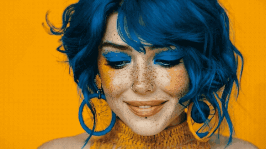 Woman wearing large blue hoop earrings and gold nose stud with septum ring body jewelry